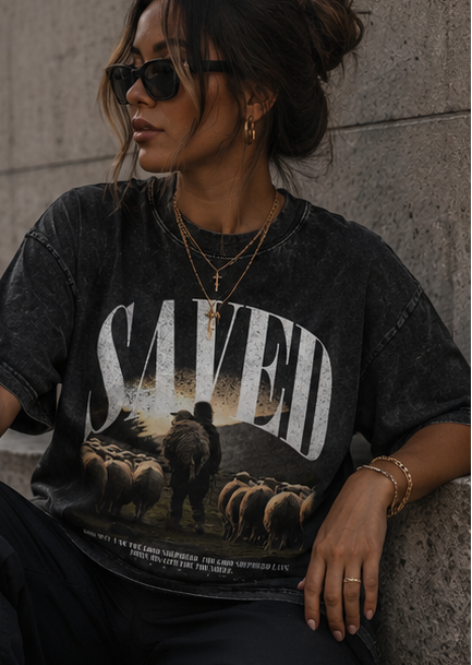Person wearing a black 'SAVED' graphic t-shirt with a bear design, shown from front, back, and side views.